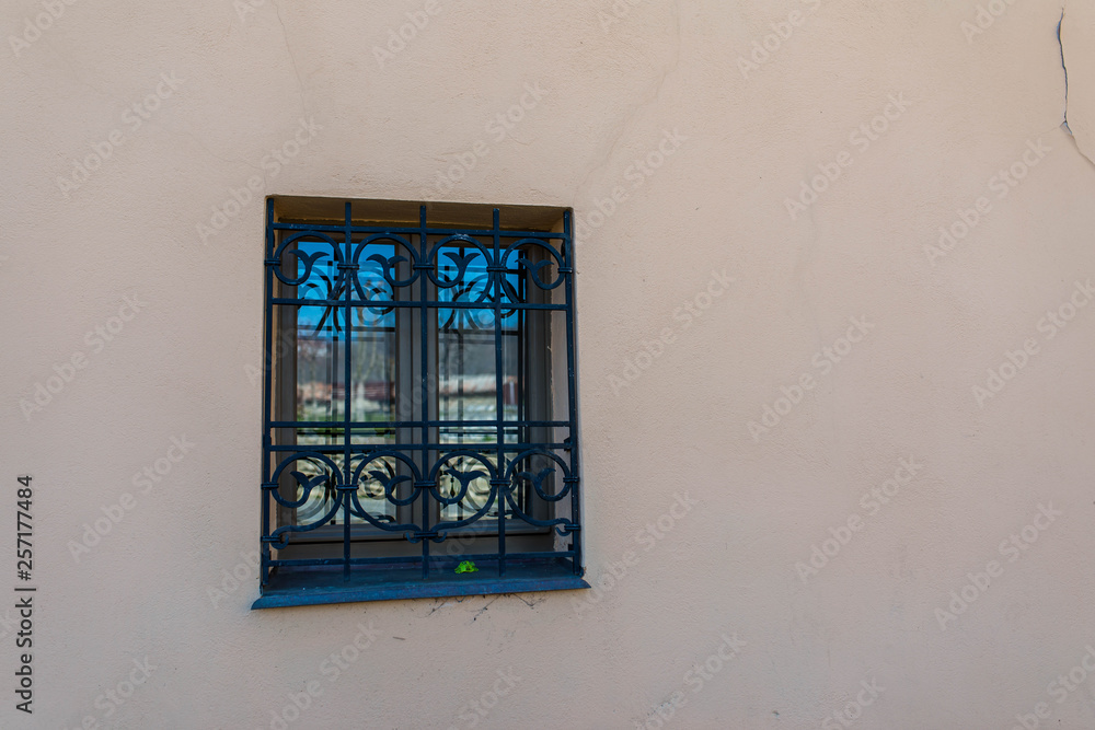 Fototapeta premium Bright colored wall with windows on the medieval streets of Sighisoara, Romania.