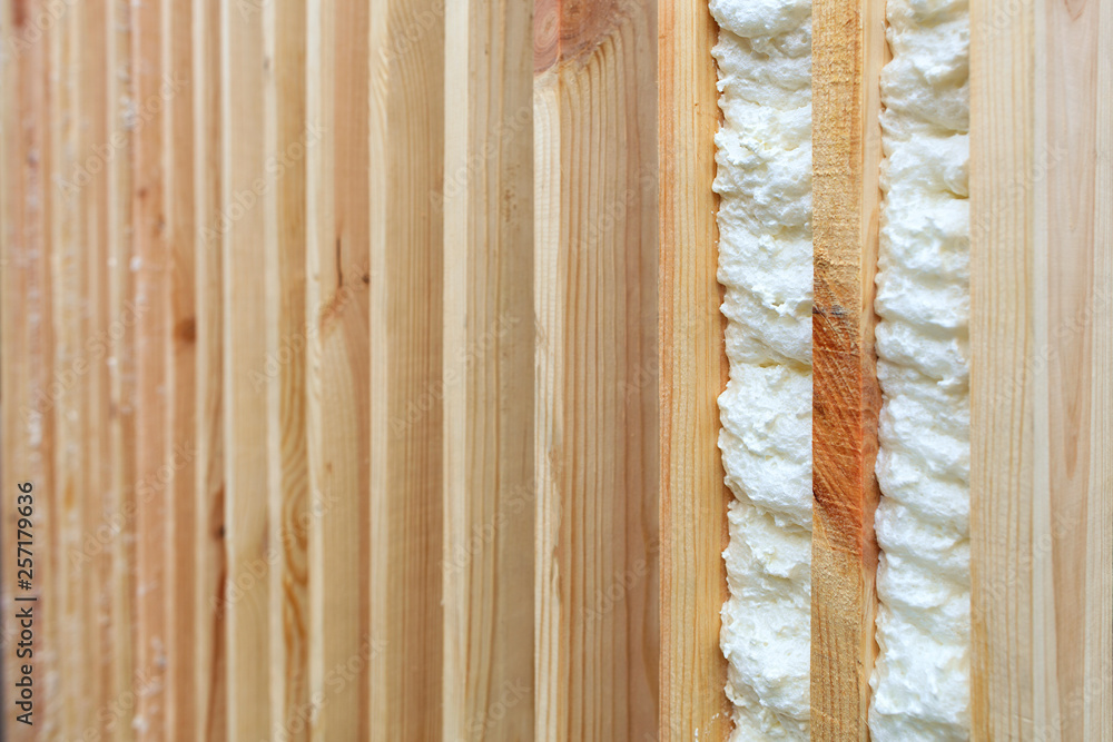 An example of filling the gap between vertical wooden planks with building foam.