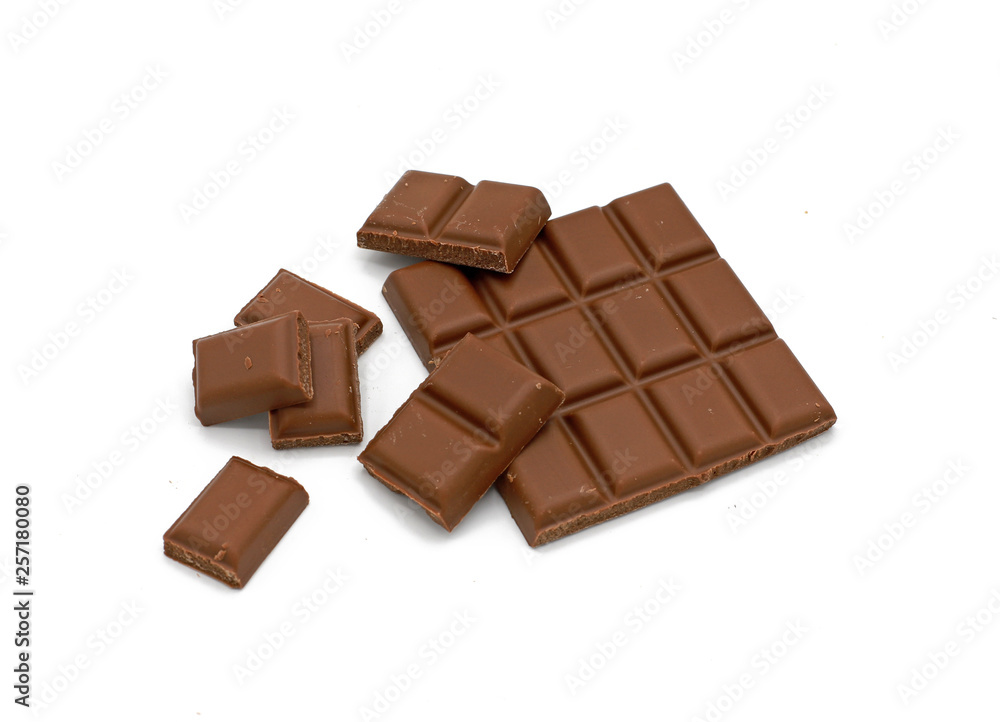 Milk chocolate bar and chocolate pieces isolated on white background