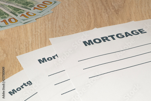 Mortgage application form with money on the table.