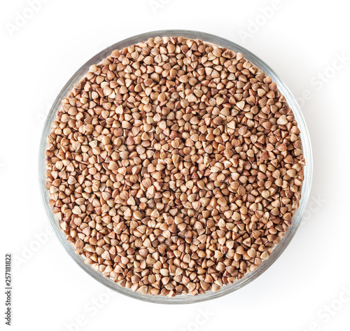 Roasted buckwheat grains in glass bowl isolated on white background with clipping path
