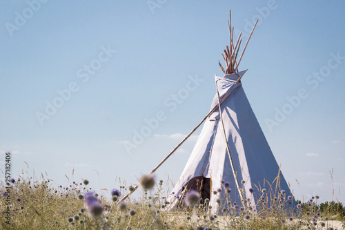 Summer vacation camping tent, indian wigwam hut, in dry wild prairie steppe desert photo