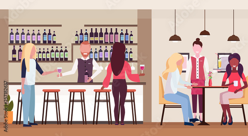 women standing at bar counter drinking alcohol bartender holding wine bottle and glass barman and waitress serving mix race clients modern cafe interior flat horizontal
