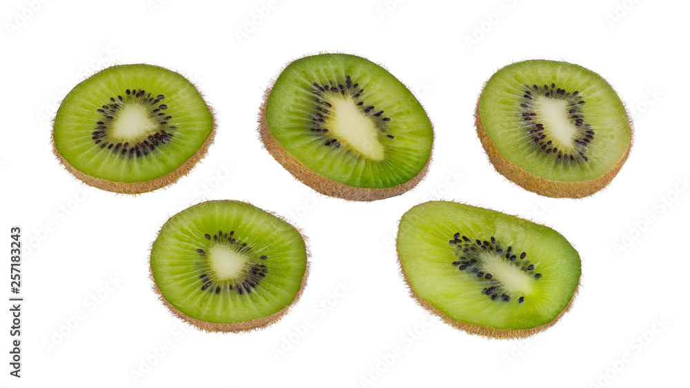 Fototapeta premium Green kiwi fruit slices. Fuzzy kiwifruit. Actinidia deliciosa. Isolated on white background. Group of sliced bio kiwis close-up. Brown skin and black seeds. Set of sweet-sour parts of tropical berry.