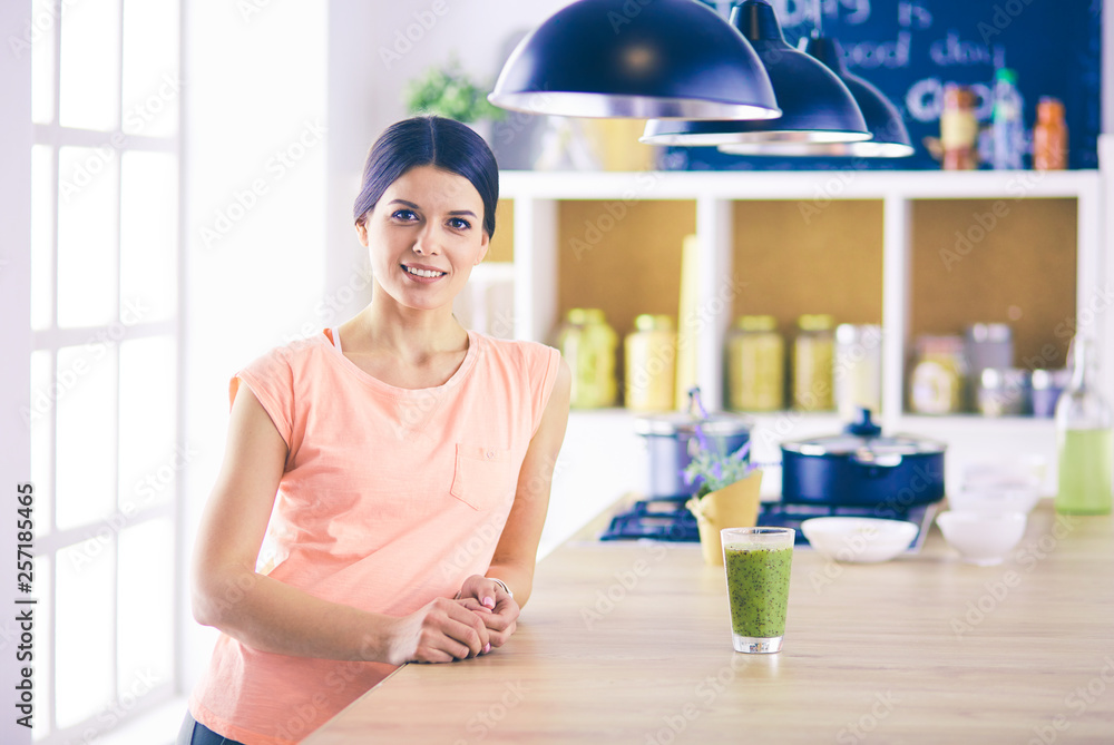 Beautiful young woman using a digital tablet in the kitchen. Beautiful young woman using a digital tablet in the kitchen.