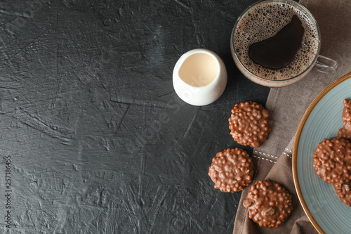 Chocolate cookies  cup of coffee and milk on black table  space for text