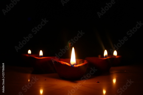 5 diyas burning in the dark front view 