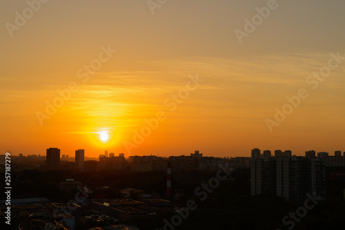 beautiful sunset over the big city with orange sky © alexnikit
