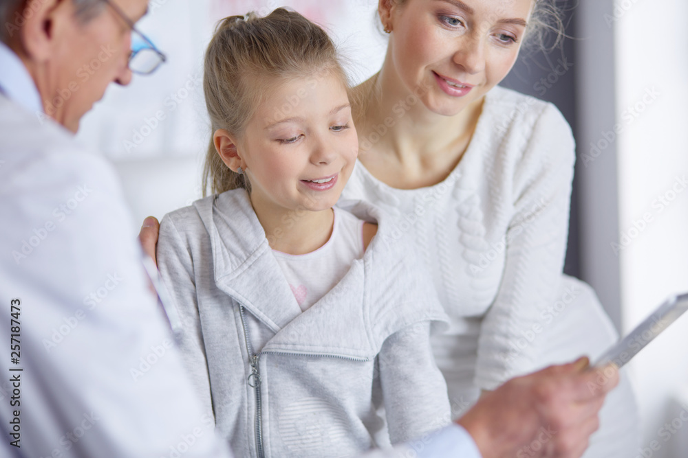 Little girl with her mother at a doctor on consultation Little girl with her mother at a doctor on consultation