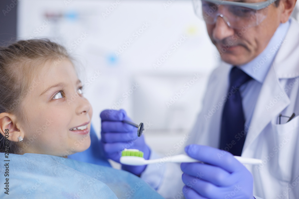 Little girl sitting in the dentists office Little girl sitting in the dentists office