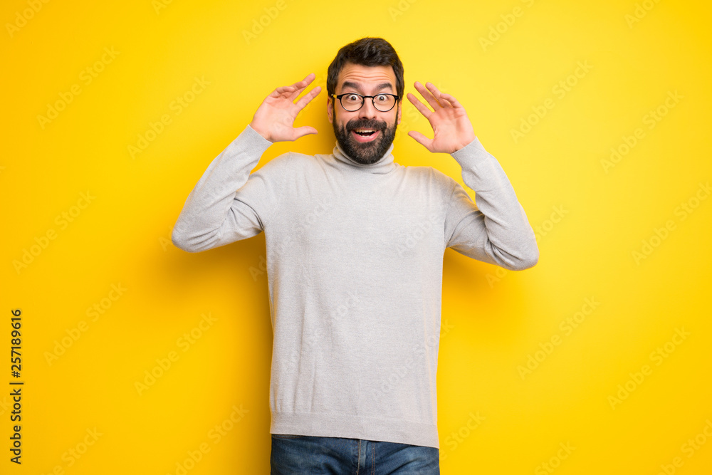 Man with beard and turtleneck with surprise and shocked facial expression Man with beard and turtleneck with surprise and shocked facial expression