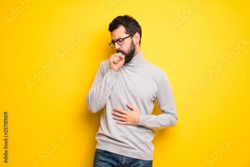Man with beard and turtleneck is suffering with cough and feeling bad