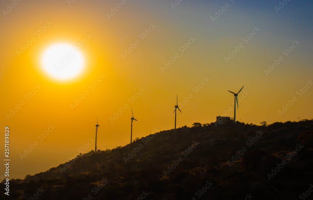 Obraz premium wind turbines at sunset
