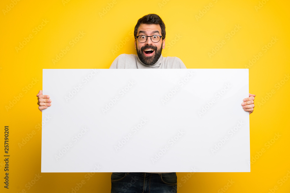 Man with beard and turtleneck holding a placard for insert a concept Man with beard and turtleneck holding a placard for insert a concept