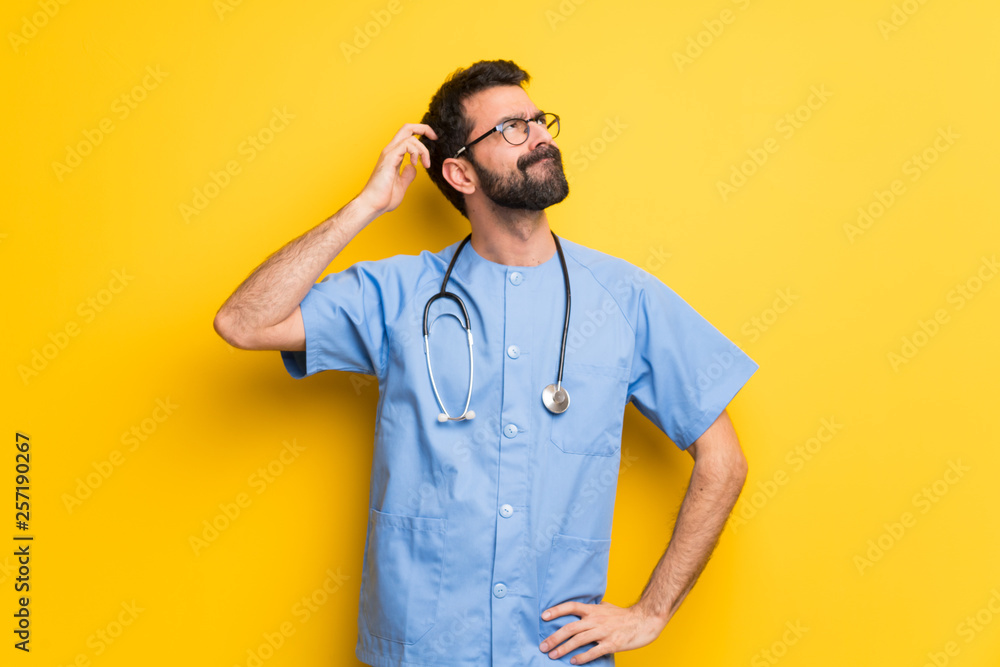 Surgeon doctor man having doubts while scratching head Surgeon doctor man having doubts while scratching head