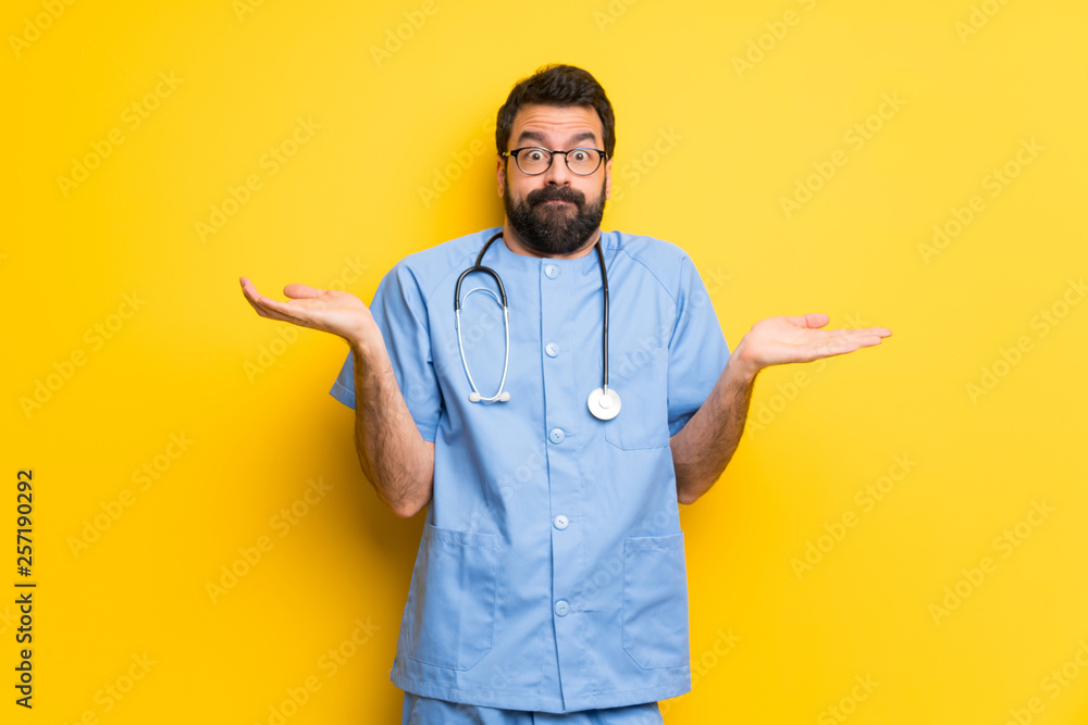 Surgeon doctor man having doubts while raising hands and shoulders Surgeon doctor man having doubts while raising hands and shoulders