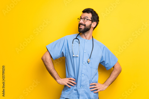 Surgeon doctor man posing with arms at hip and laughing © luismolinero