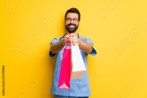Surgeon doctor man holding a lot of shopping bags