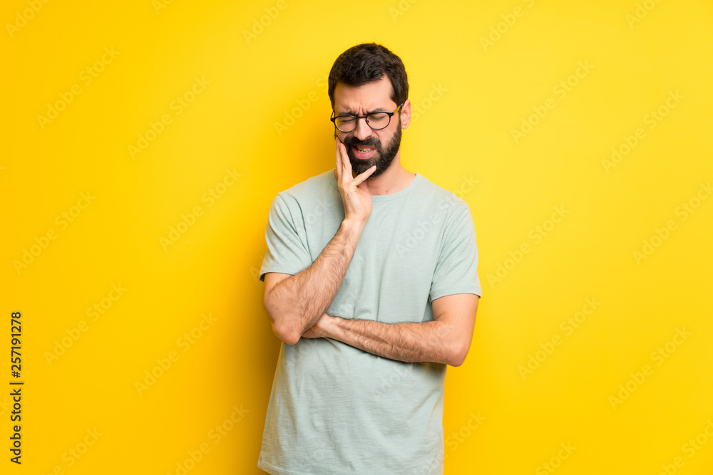 Man with beard and green shirt with toothache Man with beard and green shirt with toothache