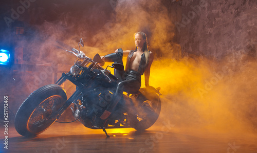 Young woman sitting on motorcycle