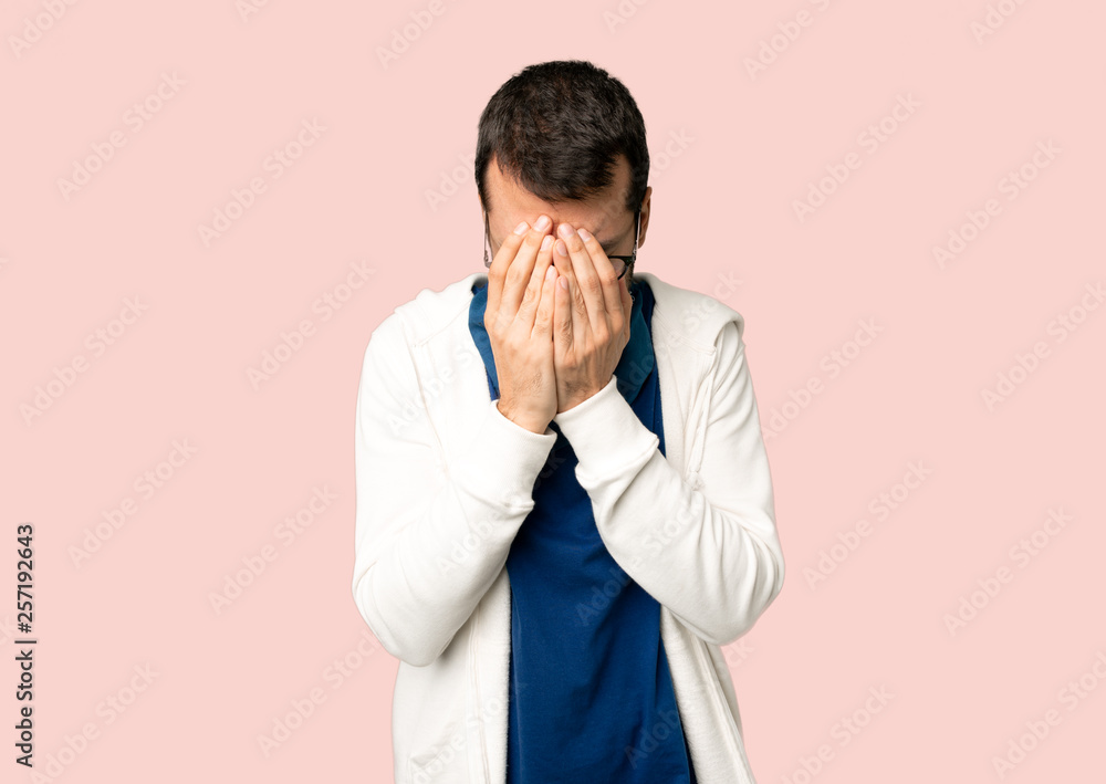 Handsome man with glasses with tired and sick expression on isolated pink background Handsome man with glasses with tired and sick expression on isolated pink background