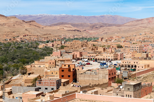 Fortified city of Tinghir along the former caravan route between the Sahara and Marrakech in Morocco with snow covered Atlas mountain range in background