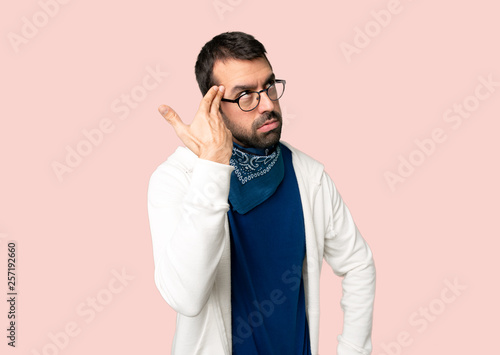 Handsome man with glasses with problems making suicide gesture on isolated pink background