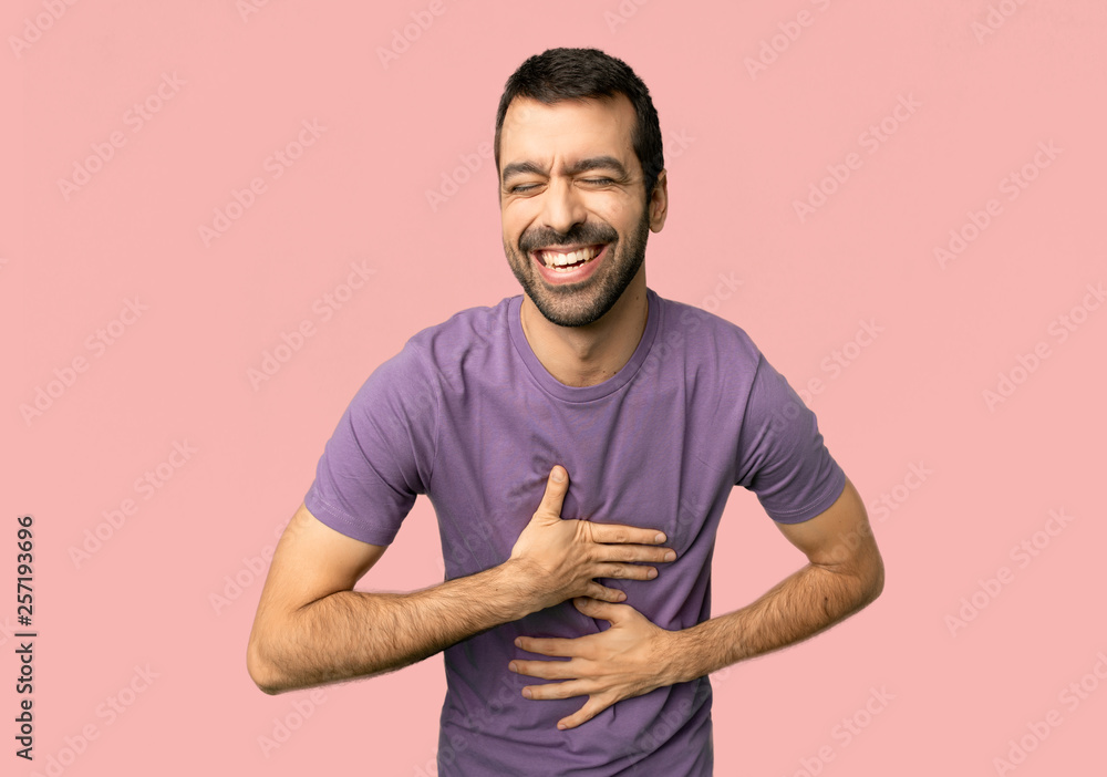 Handsome man smiling a lot while putting hands on chest on isolated pink background Handsome man smiling a lot while putting hands on chest on isolated pink background