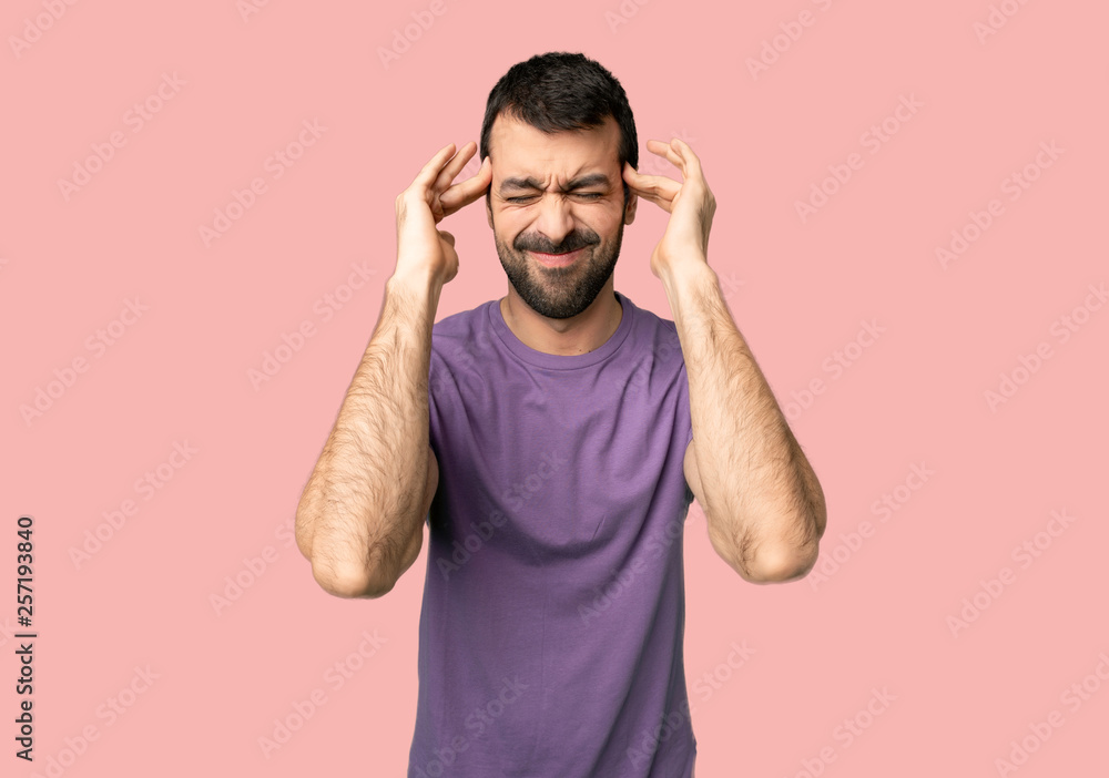 Handsome man unhappy and frustrated with something on isolated pink background Handsome man unhappy and frustrated with something on isolated pink background