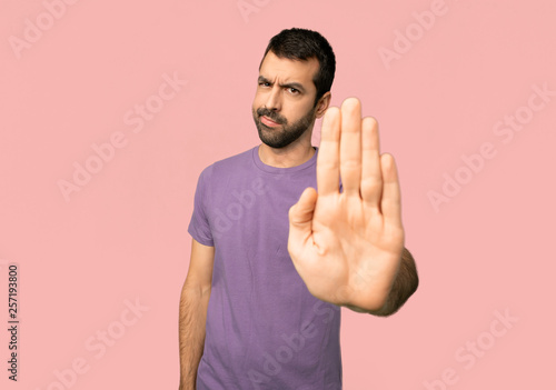 Obraz na plátně Handsome man making stop gesture denying a situation that thinks wrong on isolat