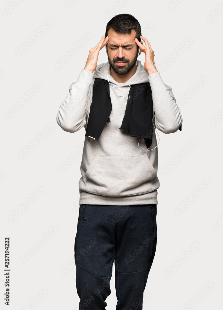 Sport man unhappy and frustrated with something over isolated grey background Sport man unhappy and frustrated with something over isolated grey background