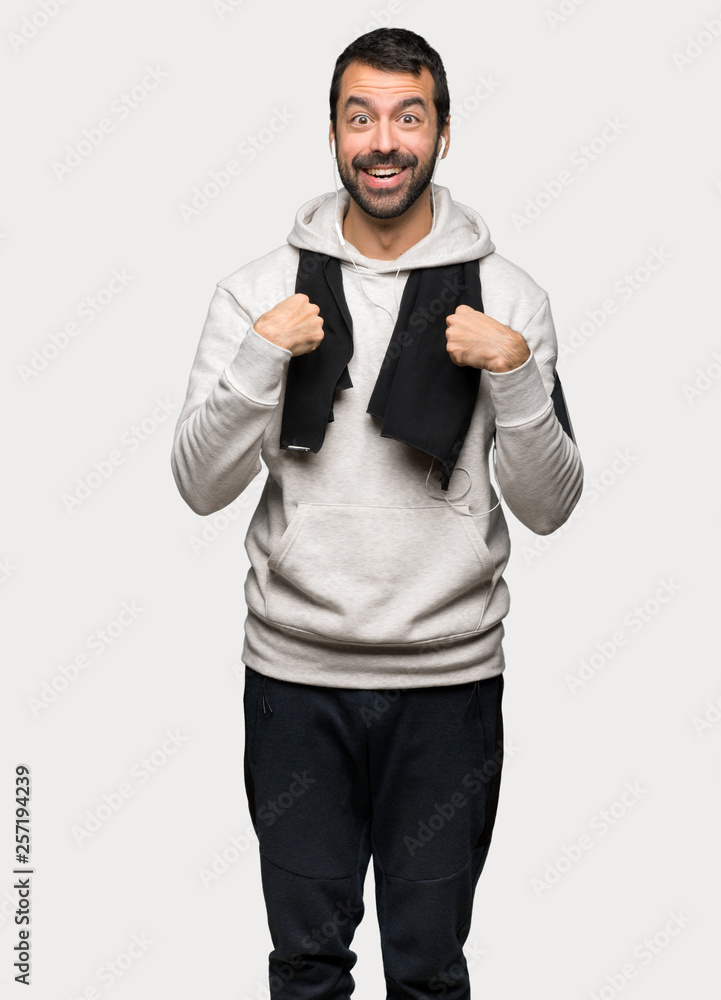 Sport man with surprise facial expression over isolated grey background Sport man with surprise facial expression over isolated grey background