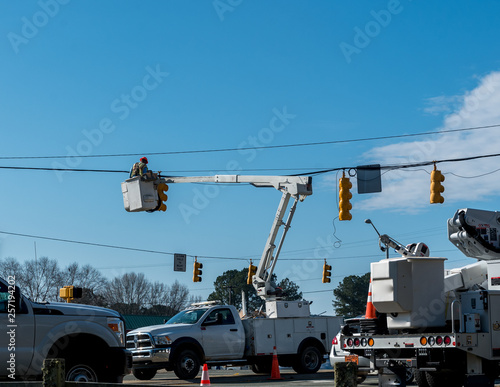 Power company worker repairing traffic light