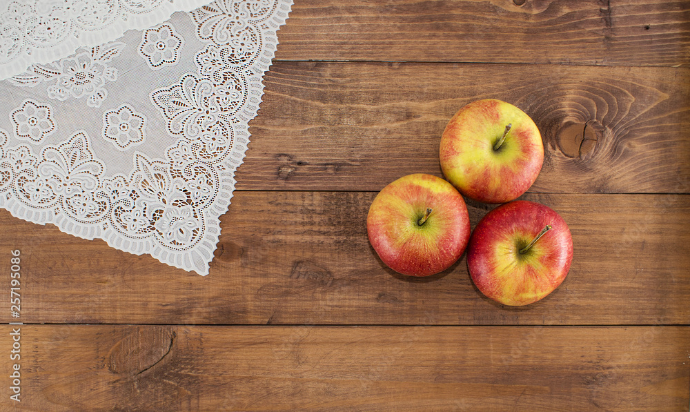 Apples on a wooden background and lace napkin. Proper diet. Healthy diet. Vegetarianism. Proper Breakfast. The right snack. Apples on a wooden background and lace napkin. Proper diet. Healthy diet. Vegetarianism. Proper Breakfast. The right snack.