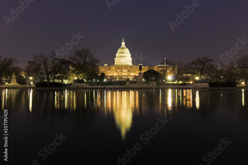 Stunning night-time reflection of the United States Capitol Building on the surface of the Capitol Reflecting Pool, Union Square, Washington DC