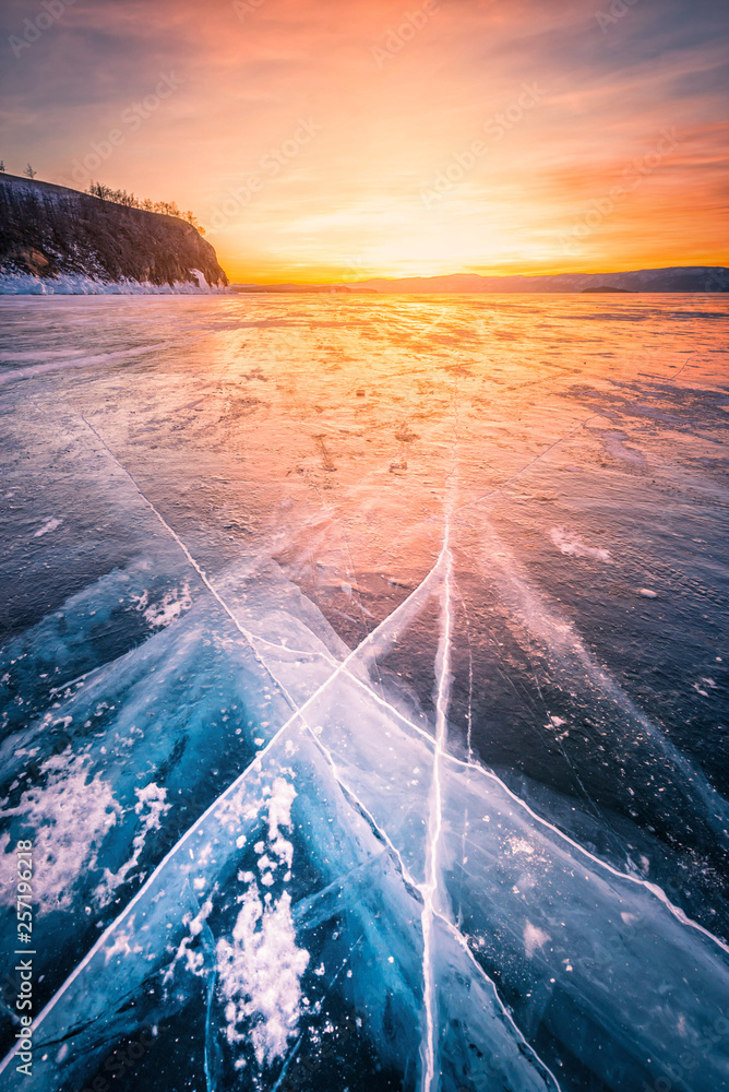 Sunset sky with natural breaking ice over frozen water on Lake Baikal, Siberia, Russia. - obrazy, fototapety, plakaty 