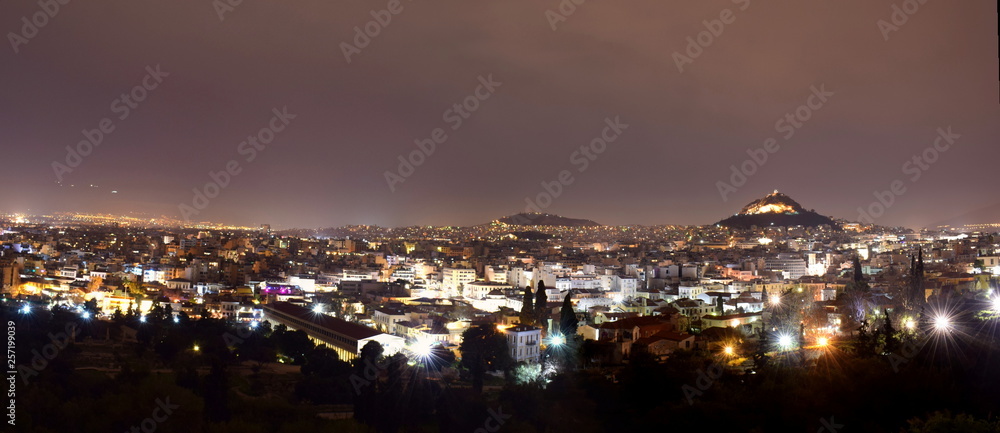 Image shows a night view of the capital of Greece-Athens shot from the  Areopagus hill located next to Acropolis.