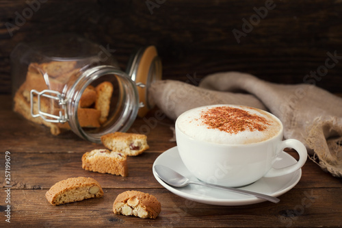 cup of cappuccino coffee with cookies photo