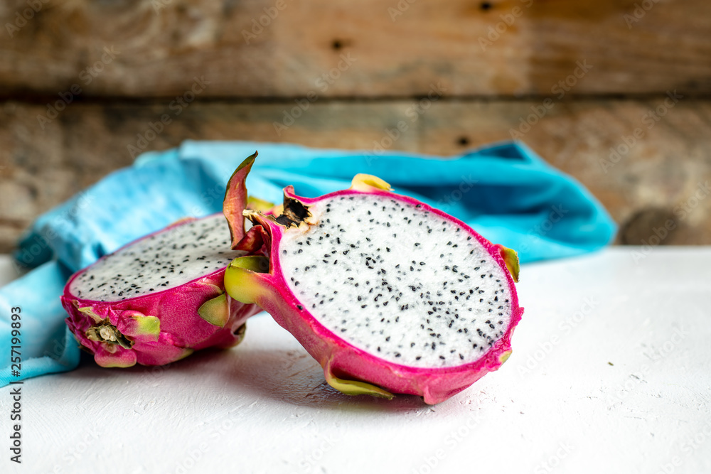 halved pink and green dragon fruit with white flesh halved pink and green dragon fruit with white flesh