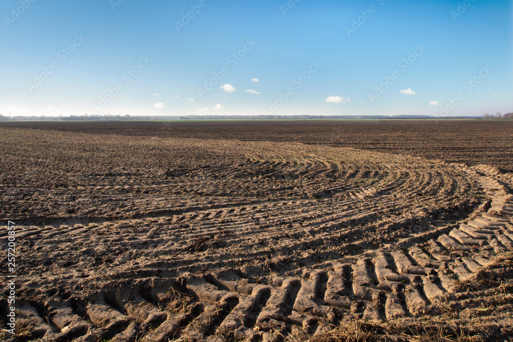 Tractor tracks on freshly plughed soil in the field Tractor tracks on freshly plughed soil in the field