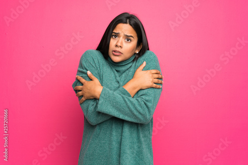 Young Colombian girl with green sweater freezing © luismolinero