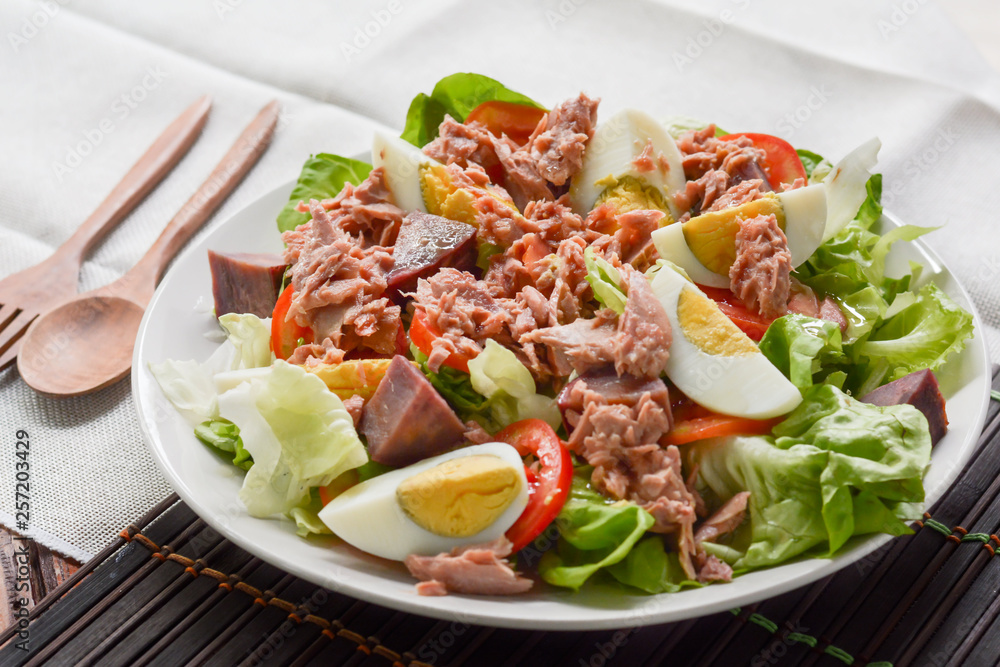 tuna salad with boiled egg, tomato slice, sweet potato and lettuce on white dish. Healthy food for loose weight, high fiber and low fat. tuna salad with boiled egg, tomato slice, sweet potato and lettuce on white dish. Healthy food for loose weight, high fiber and low fat.