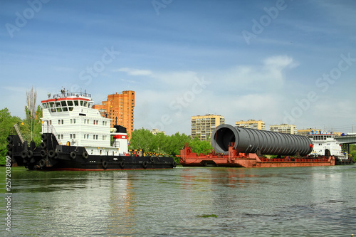 Canvas Print Heavy oversized chemical apparatus is transported by river transport through the
