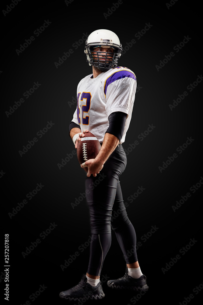 American football sportsman player on black background. Sport concept. American football sportsman player on black background. Sport concept.