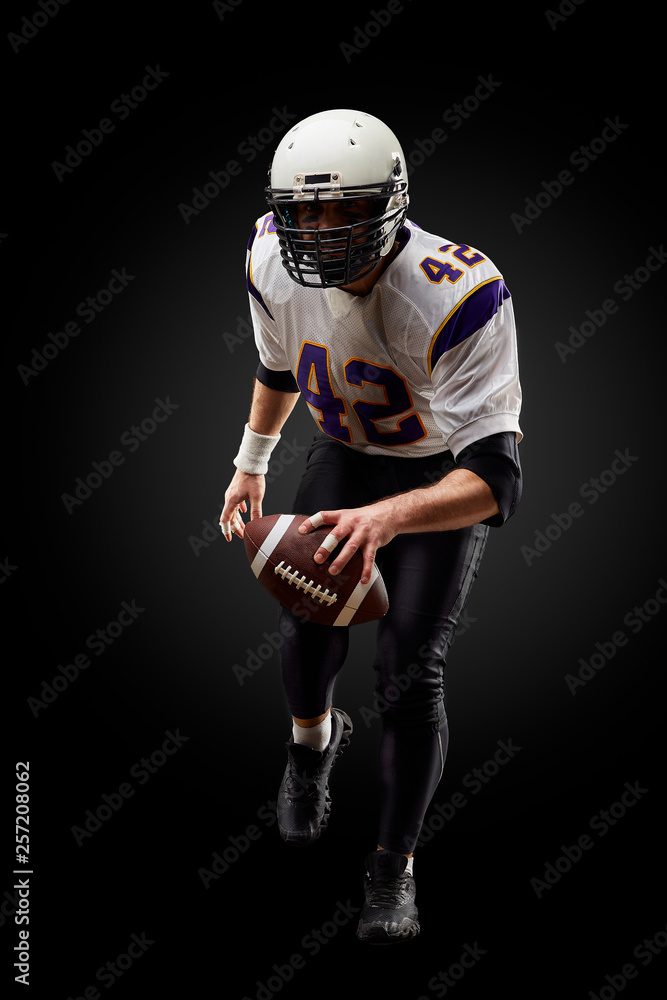 American football sportsman player on black background. Sport concept. American football sportsman player on black background. Sport concept.