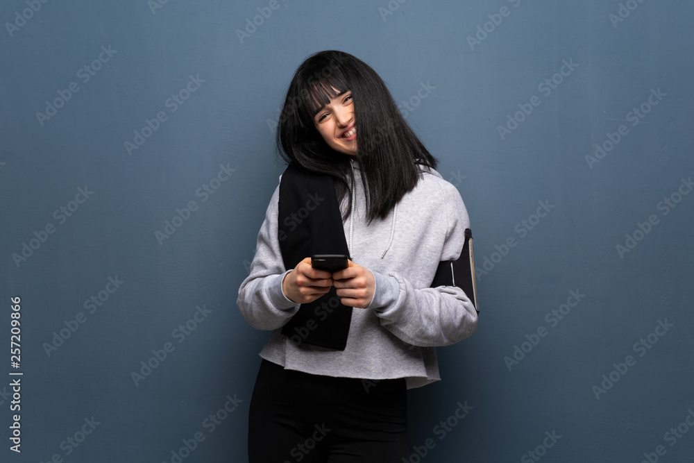 Young sport woman sending a message with the mobile Young sport woman sending a message with the mobile
