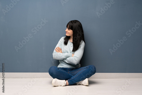 Woman sitting on the floor in lateral position