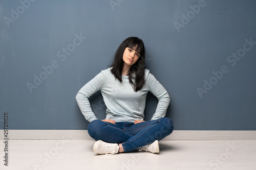 Woman sitting on the floor angry