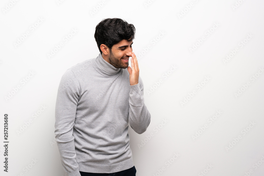 Young man over isolated white wall smiling a lot Young man over isolated white wall smiling a lot