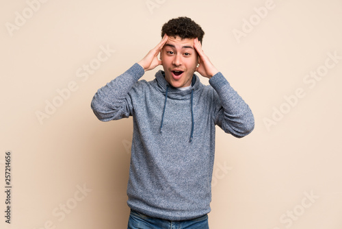 Young man over isolated wall with surprise expression